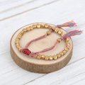 Pulsera tibetana con cuentas cobrizas y cordón multicolor