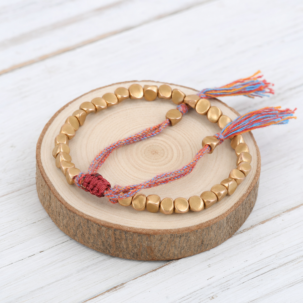 Pulsera tibetana con cuentas cobrizas y cordón multicolor